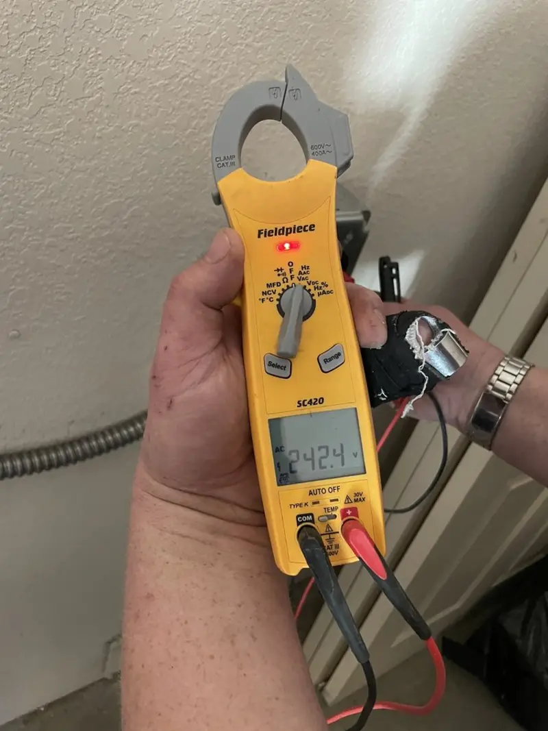 Voltage testing with clamp meter during Ceiling Fan Installation in Derry